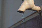 Tap with a water drop dripping from it